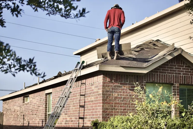 Professional roofer working on a residential roof in Pine Neck